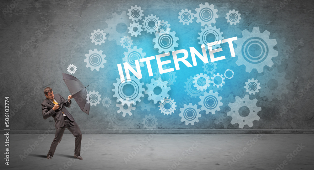 Fototapeta premium Businessman defending with umbrella concept