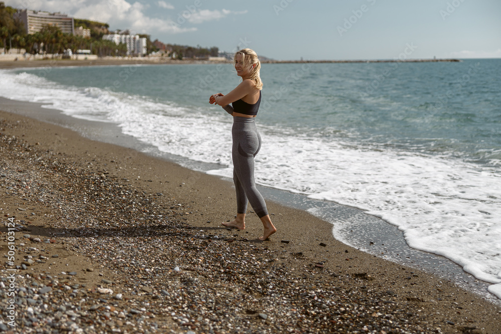 Caucasian sporty woman exercising near beautiful coast