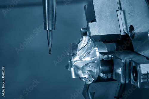 Close up scene the  4-axis  machining center cutting the turbocharger parts with solid ball end mill tool. photo