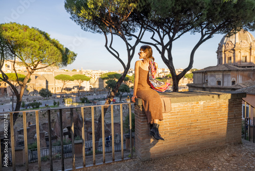 Woman enjoying beautiful view from above on the old centre of Rome on a sunset. Concept of a happy vacations and traveling Italy. © rh2010