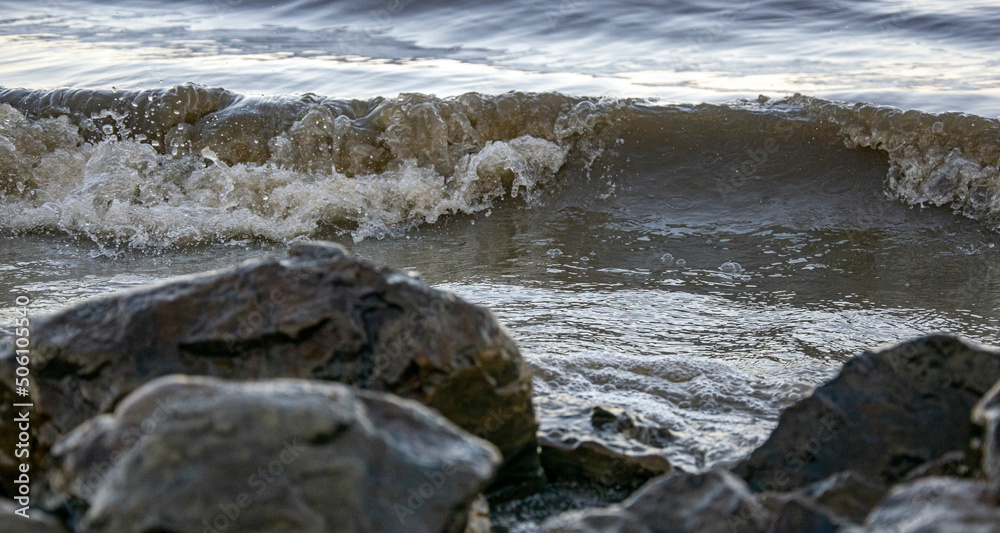 background sandy beach with waves and rocks