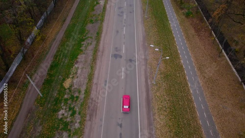 Wallpaper Mural Red car driving on the road in the forest Torontodigital.ca