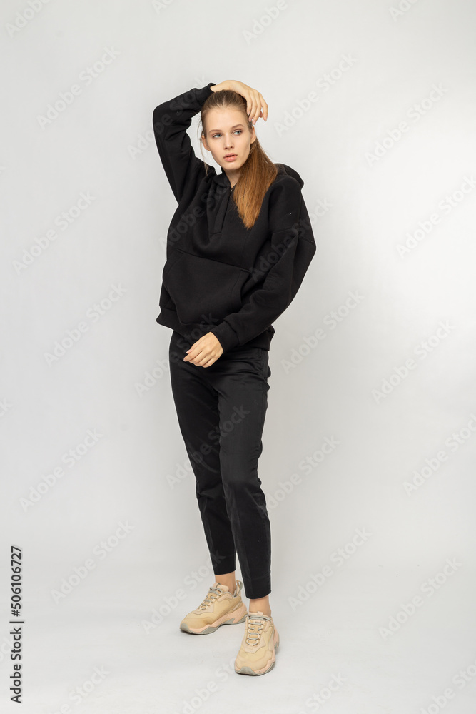 Girl in black cargo pants and black hoodie isolated on white Girl in black cargo pants and black hoodie isolated on white