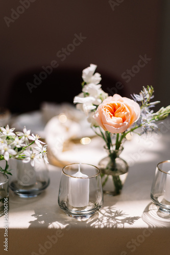 Dinner table decorated by candles and flowers. Wedding. Decor