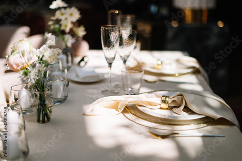 Dinner table decorated by candles and flowers. Wedding. Decor