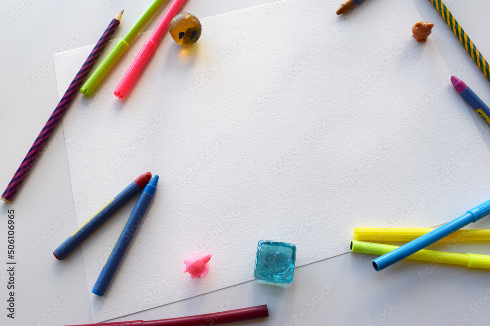 Color felt-tip pens and pencils, notepad and white sheet, top view. Creative artistic mockup with copyspace Color felt-tip pens and pencils, notepad and white sheet, top view. Creative artistic mockup with copyspace
