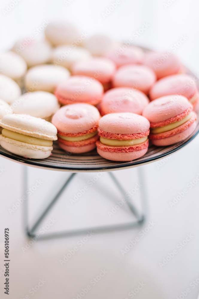 Fototapeta premium stylish children's candybar with a cake and macarons for a one year party in gentle tones of white and pink colors