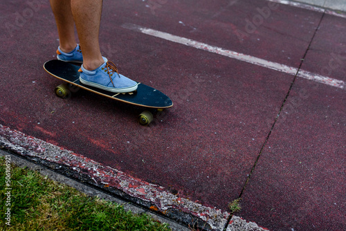 Close-up from above men's feet in grandfathers on a skateboard.