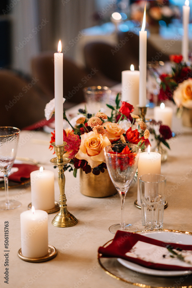 Autumn wedding table setting. Luxury stylish autumn wedding decor. Flowers and tableware on the wedding banquet. Styled romantic dinner in red color
