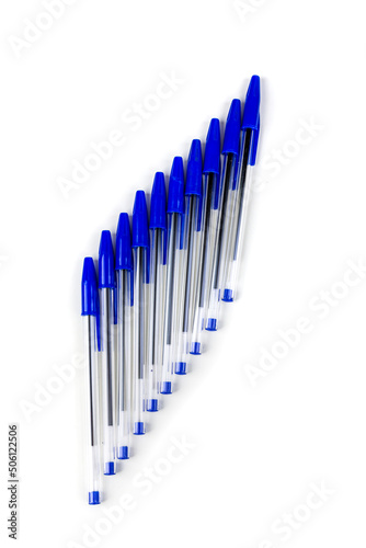 Blue writing pens  angled group of office supplies new with caps isolated over white