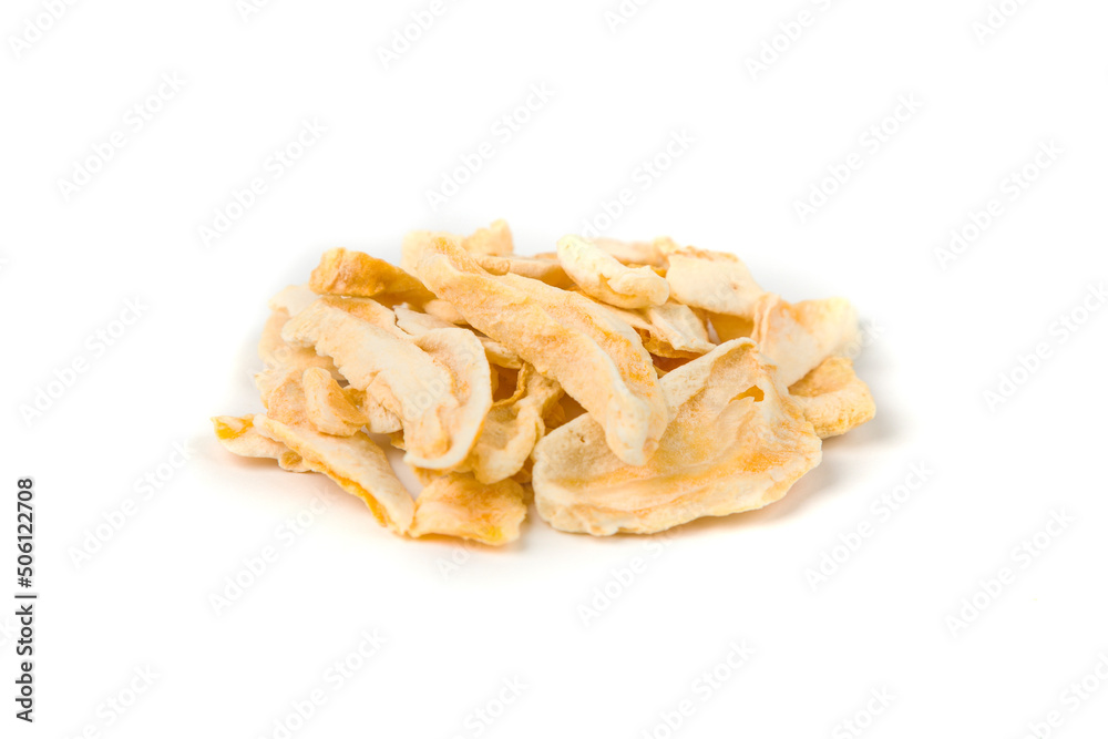 Freeze dried mango slices in a heap isolated over white.