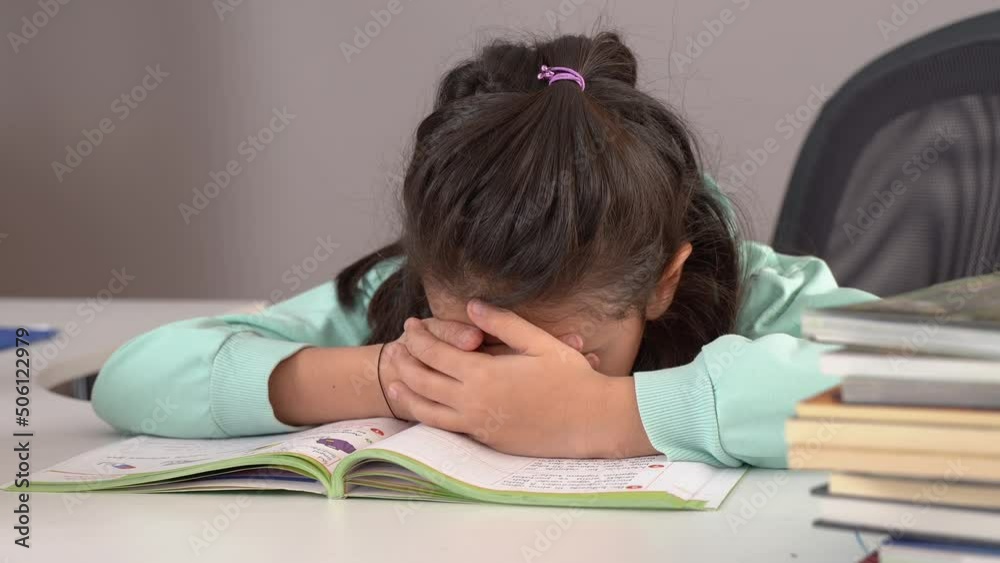 Little boy falls asleep while studying.
The little girl who does not want to study falls asleep while studying.
