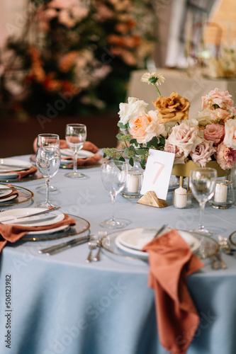 Amazing wedding table decoration with flowers on a round festive table