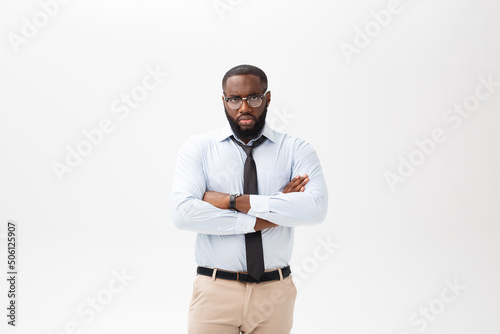 Portrait of angry or annoyed young African American man in white polo shirt looking at the camera with displeased expression. Negative human expressions, emotions, feelings. Body language.