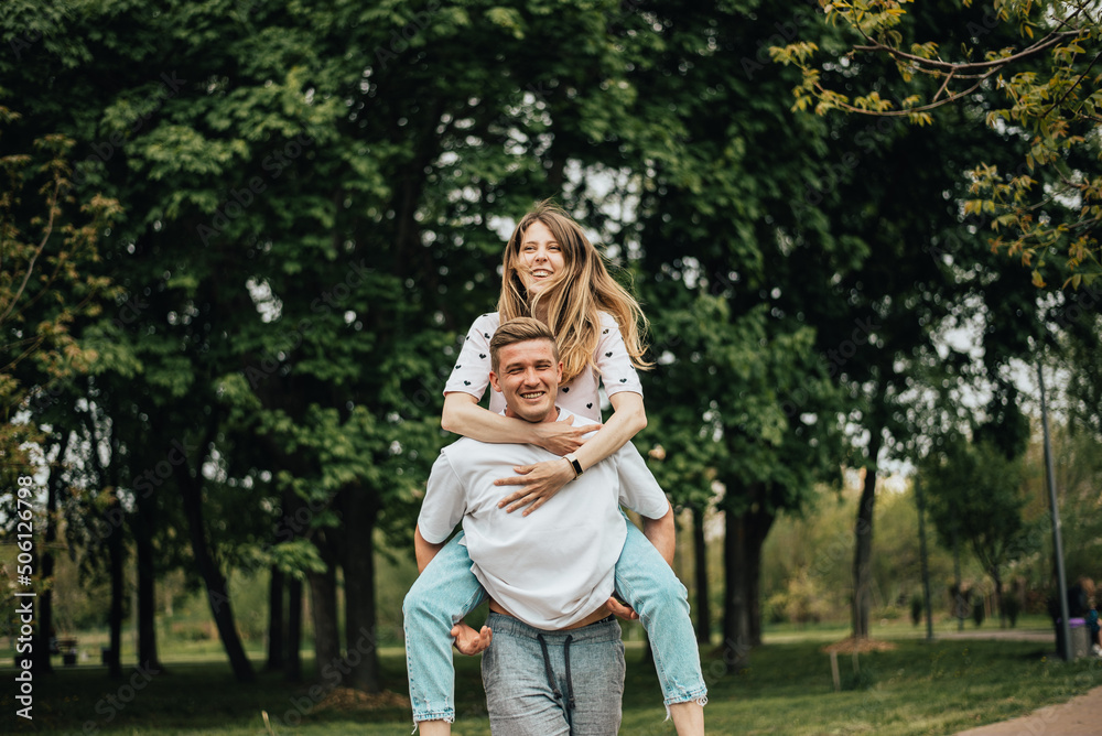 Cheerful couple. girl on guy's back Cheerful couple. girl on guy's back