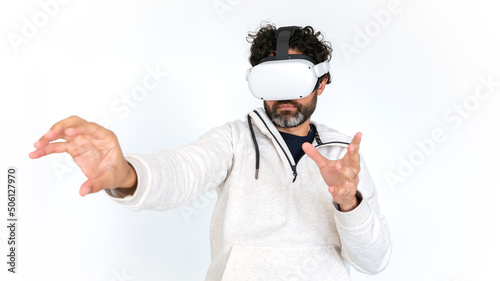 Caucasian man enjoying virtual reality glasses on white background. VR headset