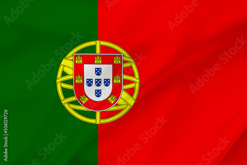 Portugal flag on waving silk background. Fabric texture.