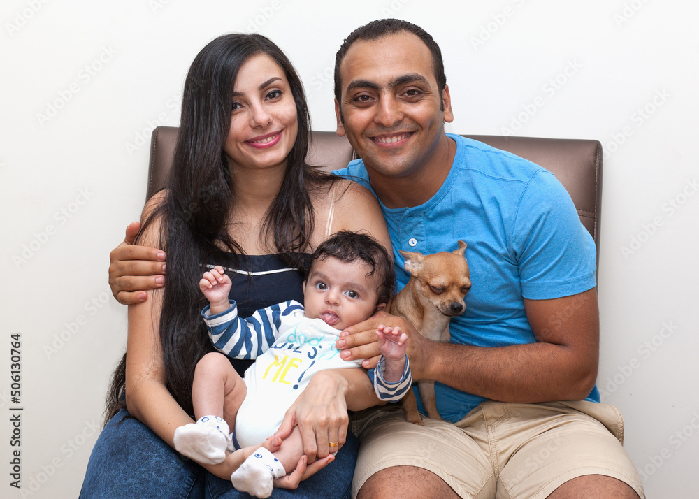 Studio portrait of a young family with a dog on a white background. High quality photo Studio portrait of a young family with a dog on a white background. High quality photo