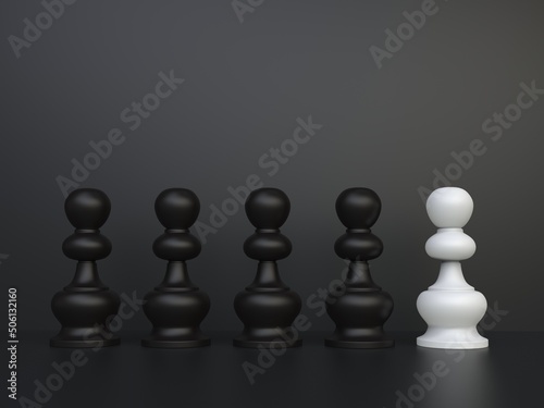 Chess pawns on dark backdrop - white one stands out