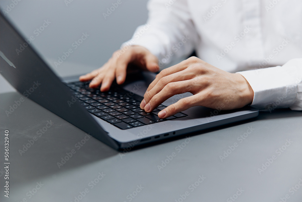 worker sits at a desk in front of a laptop Internet isolated background worker sits at a desk in front of a laptop Internet isolated background