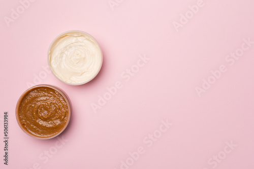 Natural scrub, body cream on color background, top view