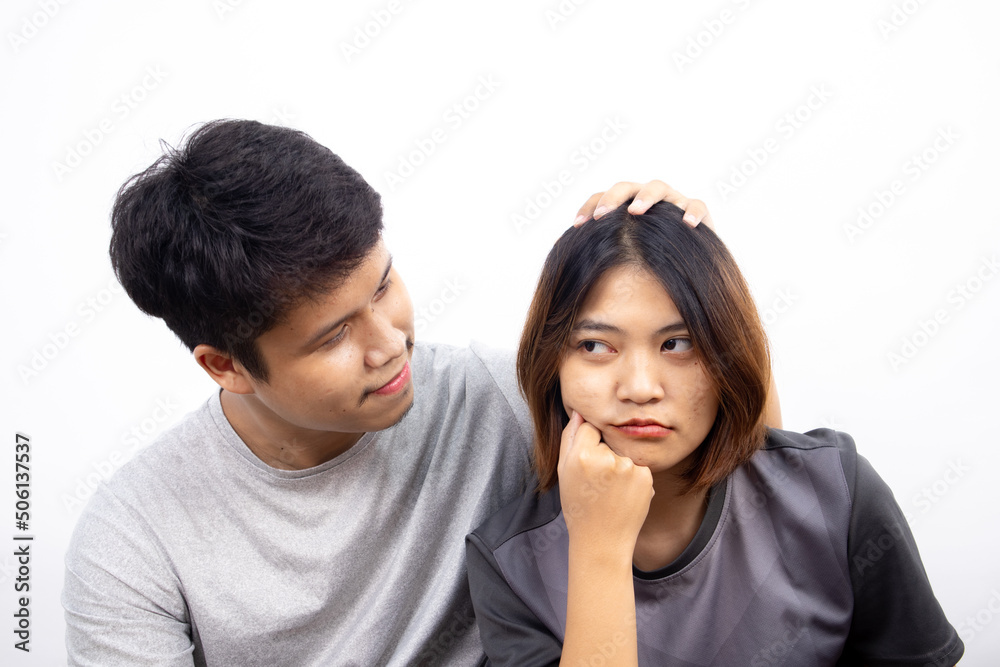Asian men are make friendly again their disgruntled girlfriend by apologizing and reconciling on white background Asian men are make friendly again their disgruntled girlfriend by apologizing and reconciling on white background