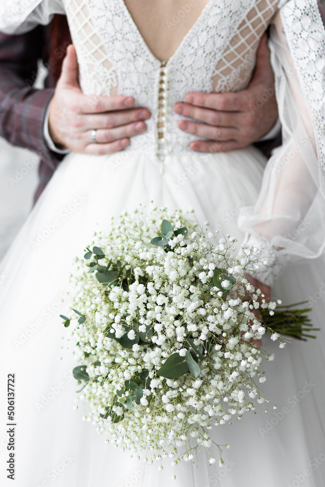 Beautiful red-hair bride in a white wedding dress and bouquet of flowers wearing pearls and a handsome groom with a red beard in a suit. Young loving couple Beautiful red-hair bride in a white wedding dress and bouquet of flowers wearing pearls and a handsome groom with a red beard in a suit. Young loving couple