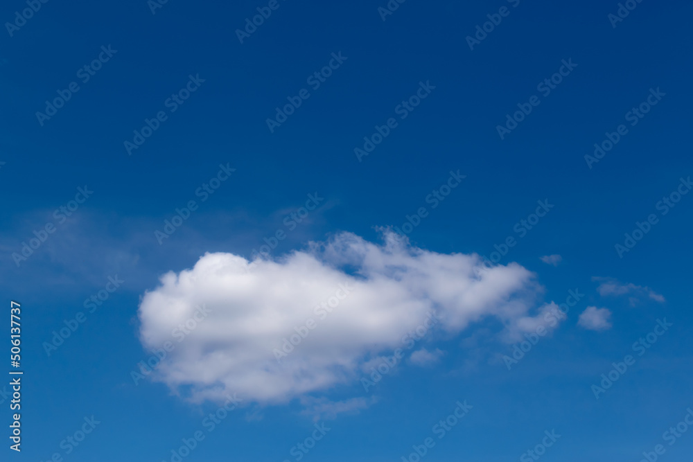A white cloud floating alone against a blue sky A white cloud floating alone against a blue sky