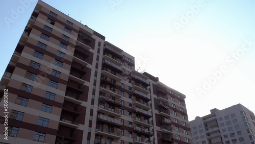 New brown high rise building ready to settlment. Blue sky background. photo