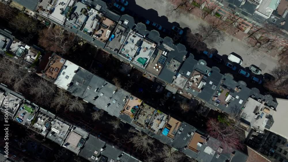 Rows of apartment houses in urban neighbourhood. Top down shot of rooftop terraces and cars parked on streets. Boston, USA Rows of apartment houses in urban neighbourhood. Top down shot of rooftop terraces and cars parked on streets. Boston, USA