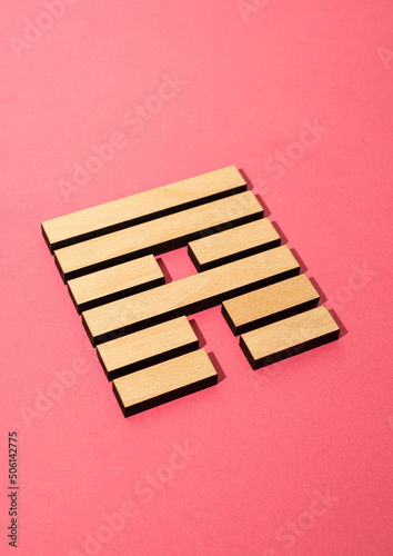 Gene Key 53 wood hexagram i ching on pink background photo