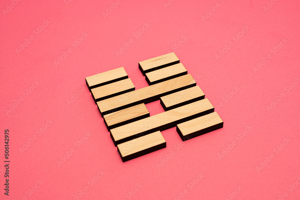 Gene Key 40 wood hexagram i ching on pink background Gene Key 40 wood hexagram i ching on pink background
