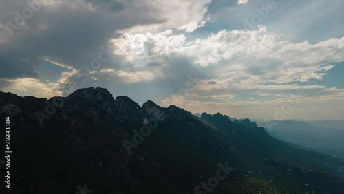 Timelapse in Chipinque, Monterrey city, Mexico, sun rays passing trough clouds over mountains photo
