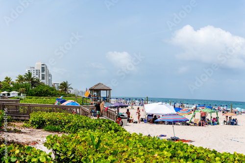 panoramic view of city with beach and people enjoying the sun.