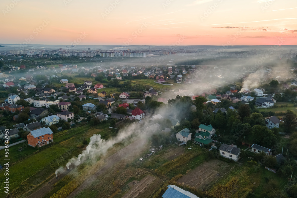 Aerial view of agricultural waste bonfires from dry grass and straw stubble burning with thick smoke polluting air during dry season on farmlands