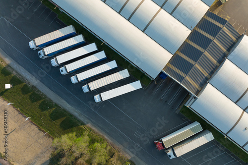 Aerial view of goods warehouses and logistics center in industrial city zone from above