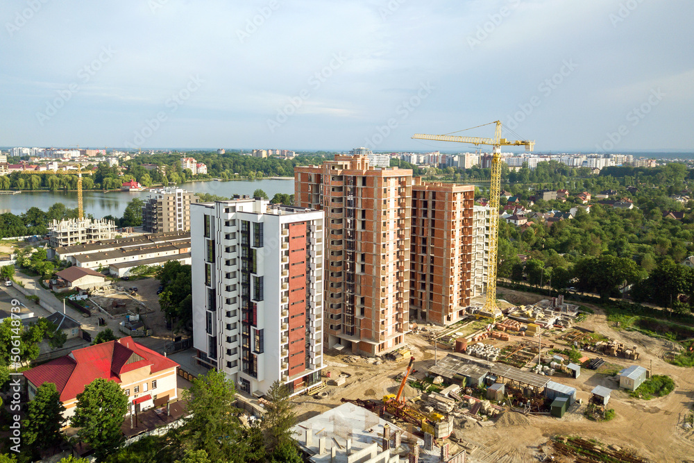 Obraz premium Aerial view of tall residential apartment buildings under construction. Real estate development.