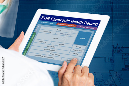 Picture looking through the shoulder of female doctor working on electronic health record.