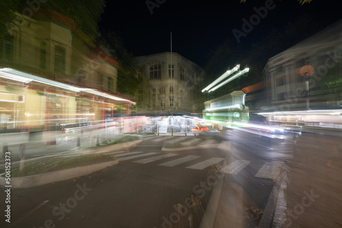 Night time in the city in zoom blur conveying frenetic urban pace of life and background