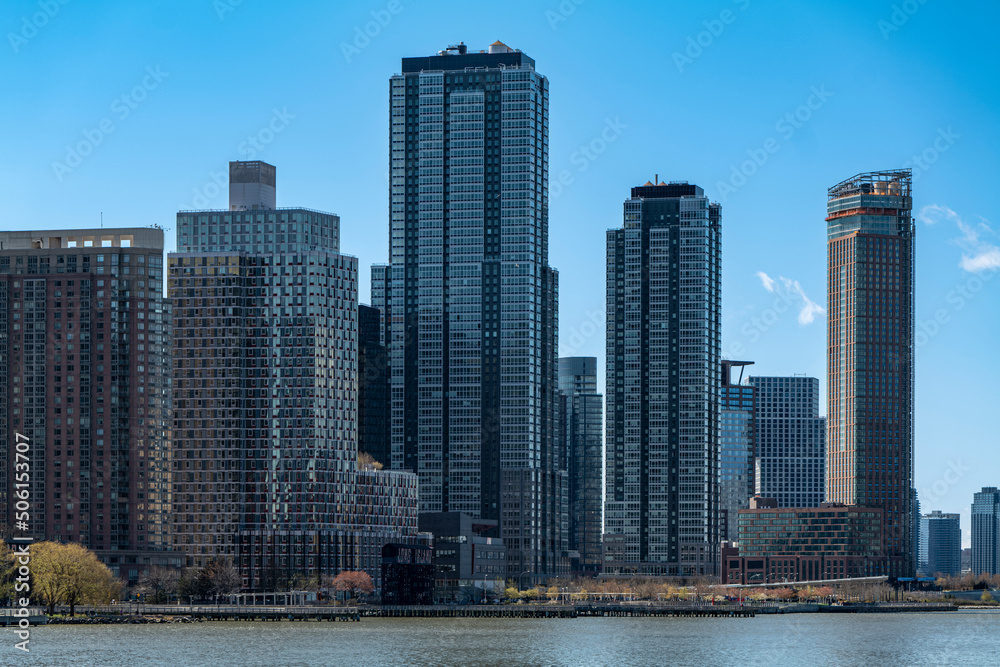 New York City skyscrapers on the river canal have a cloudy and blue sky background. High-quality photo