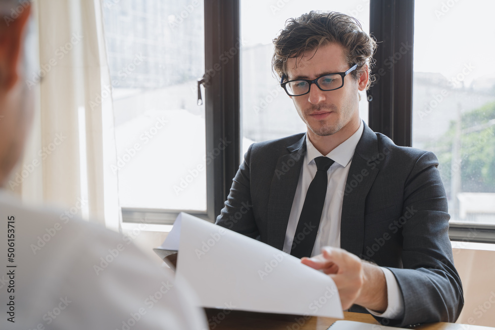 interviewer on the table asking question applicant in the office. interviewer on the table asking question applicant in the office.