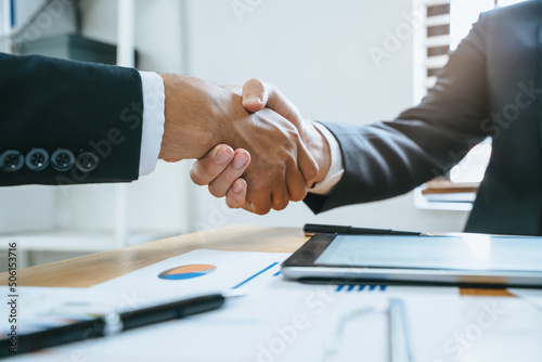 client and banker shaking hands on the meeting table after business investment budget done