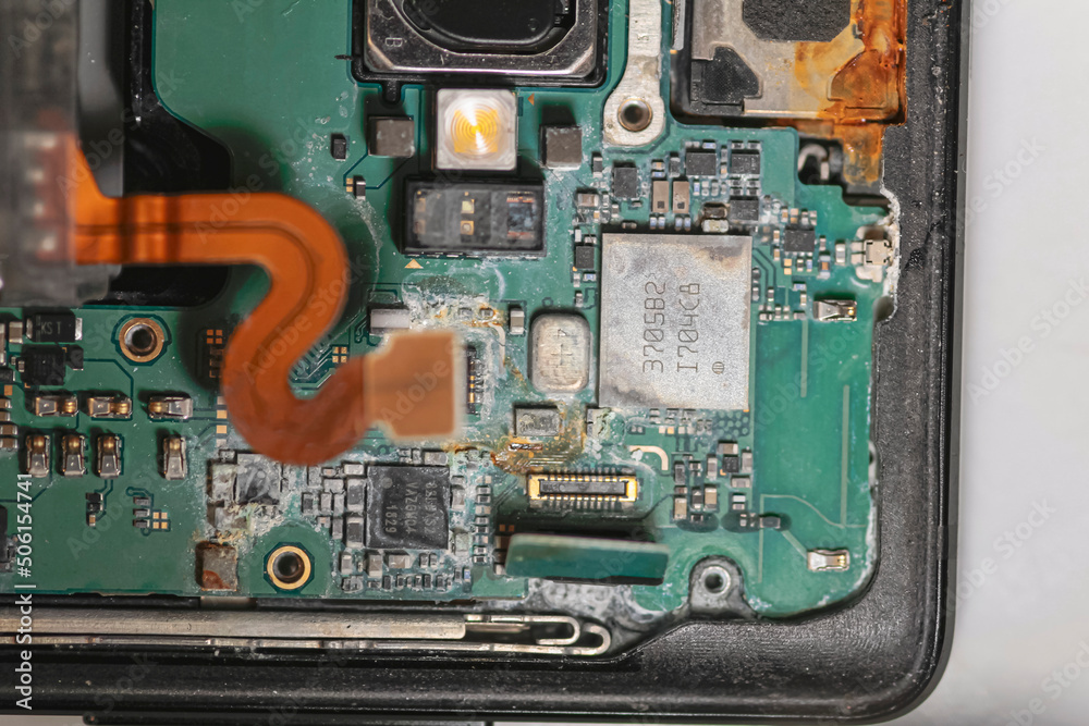 Fototapeta premium repair phone. rust on chip. microchip after water. computer hard drive. closeup of electronic part of phone circuit board. dust part of phone. repair microship on phone. dust and rust on metal part.