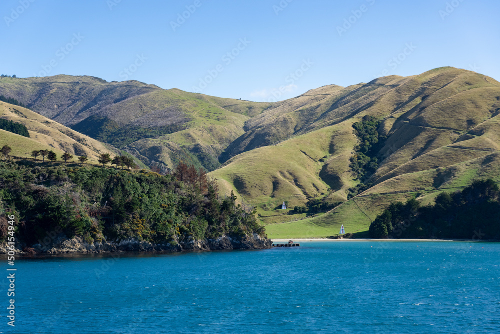 Small bay and rolling hill farmland in Marlborough Sounds viewed from sea. Small bay and rolling hill farmland in Marlborough Sounds viewed from sea.