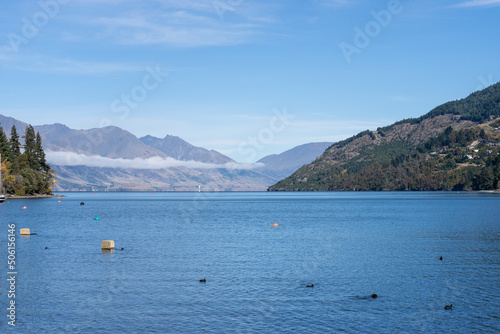 Scenic view down Lake Wakatipu from waters edge in Queenstown,.