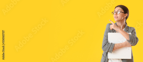 Pretty young woman holding ...