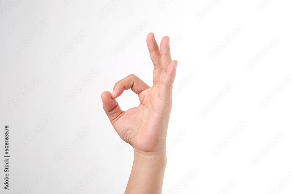 Female hand showing ok sign isolated on white background. Female hand showing ok sign isolated on white background.