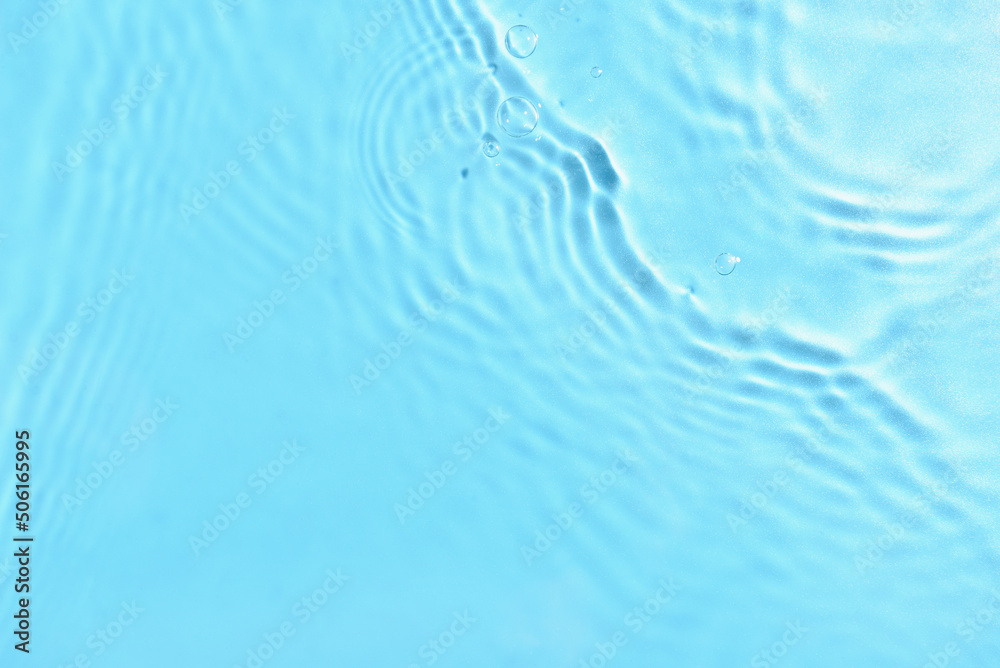 Texture of water with ripples on blue background, closeup Texture of water with ripples on blue background, closeup