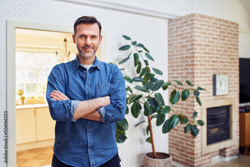 Portrait of male homeowner standing at home photo