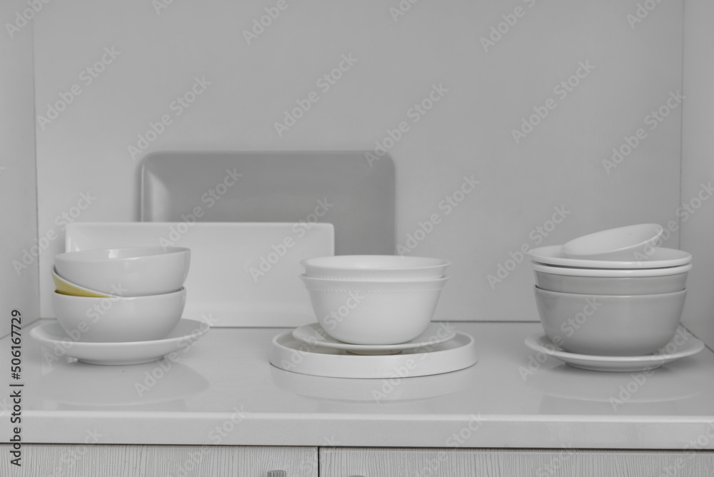Shelf with beautiful dinnerware in kitchen Shelf with beautiful dinnerware in kitchen